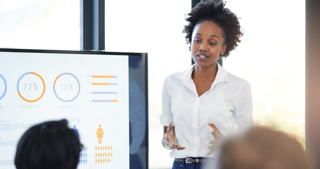 stock image of a person presenting data to a group of people