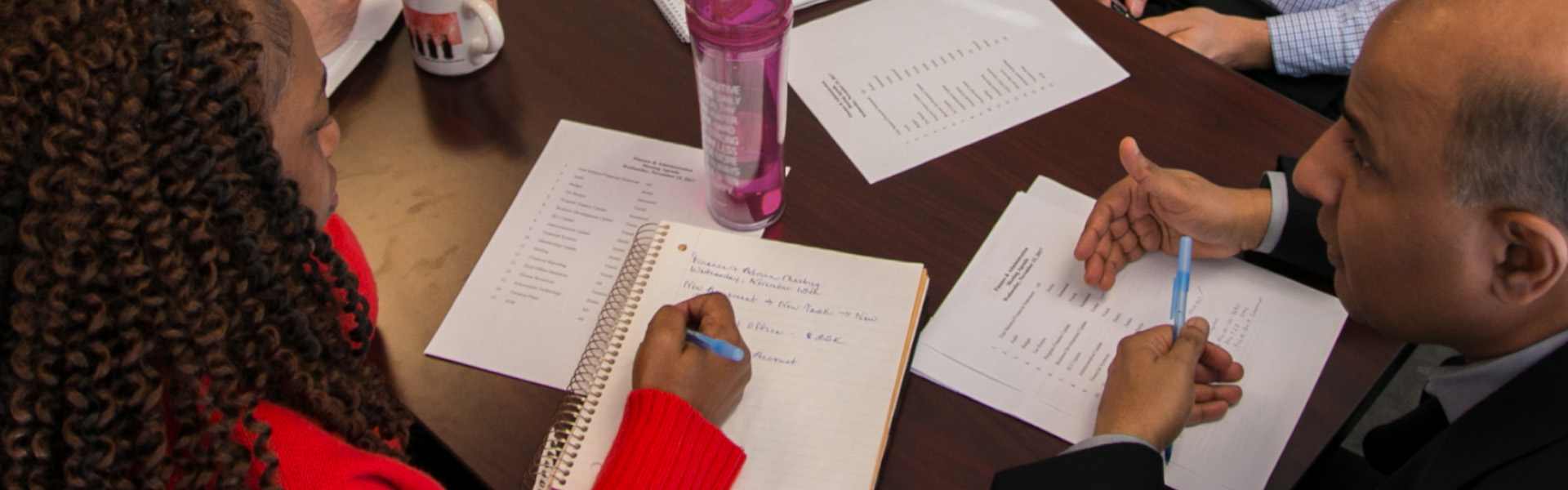 Overhead shot of hands and papers on a table