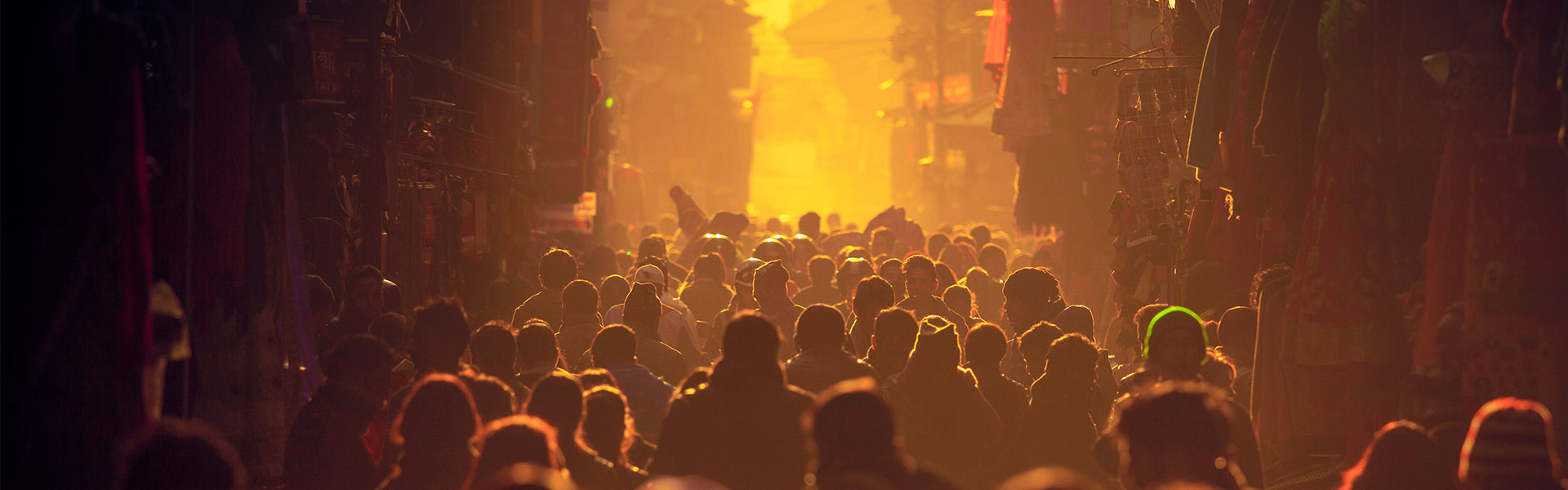 Crowded people backlit walking in street in yellow glow