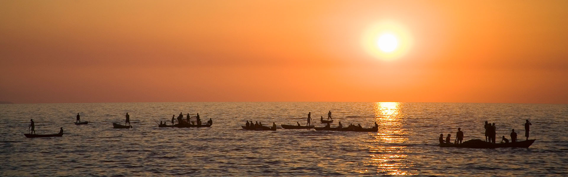 People on boats in the sunset