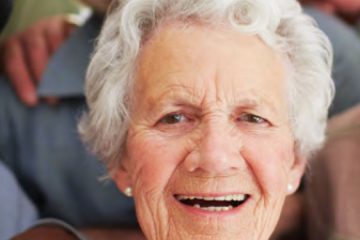 Three elderly women smiling at the camera