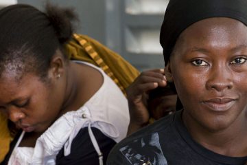 women with children looking into the camera.