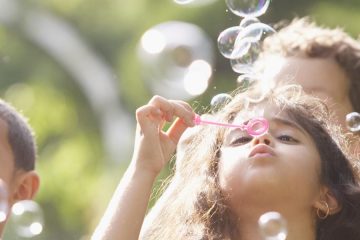 Children blowing bubbles.