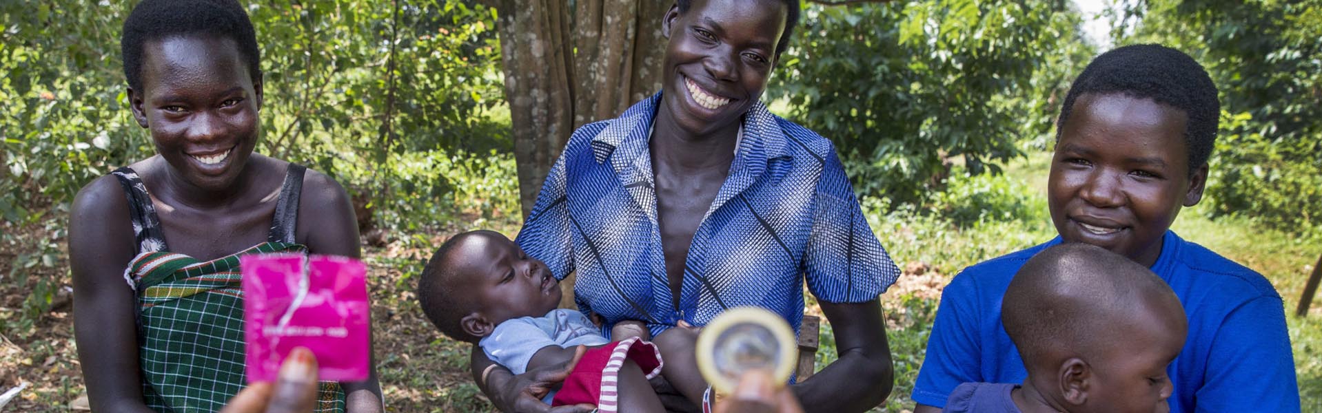 Women with children looking at a condom