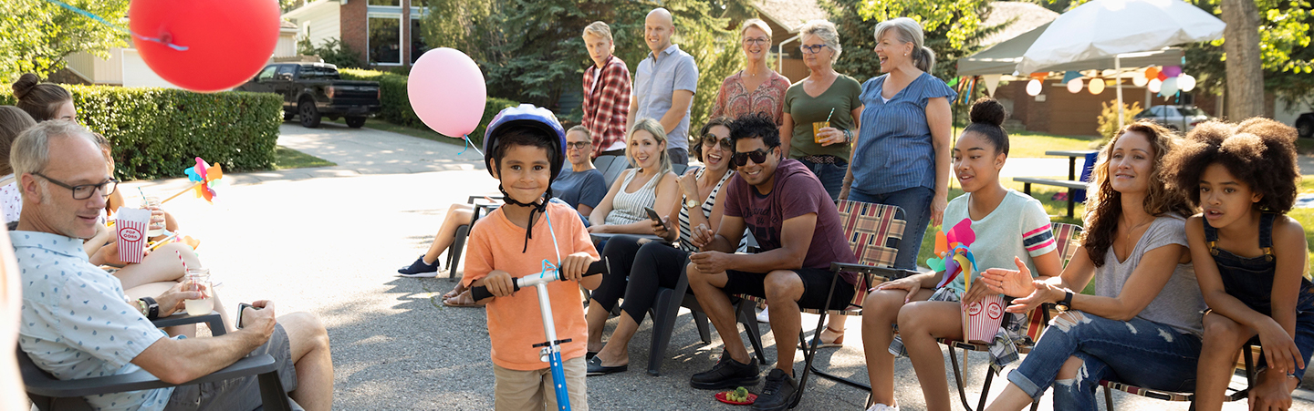 Child on a bike with crowd behind