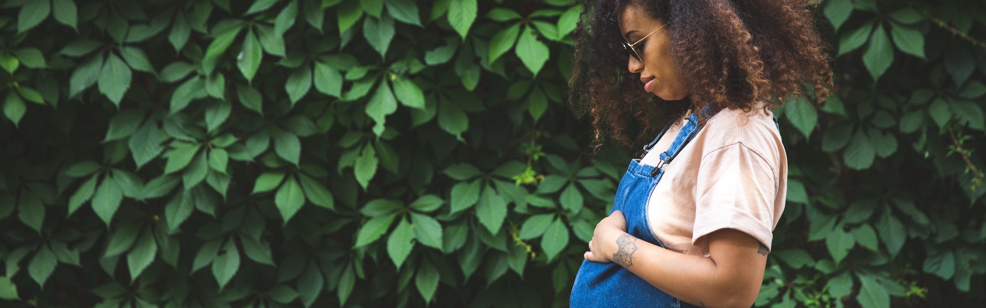 Pregnant afro hair woman in the city