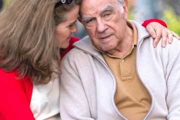 senior man possing with his daughter