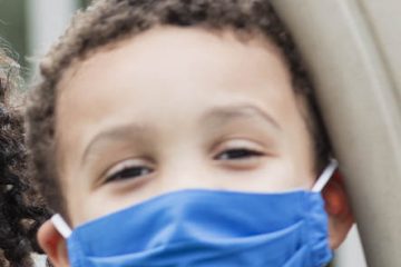 Children on playground wearing face masks, COVID-19