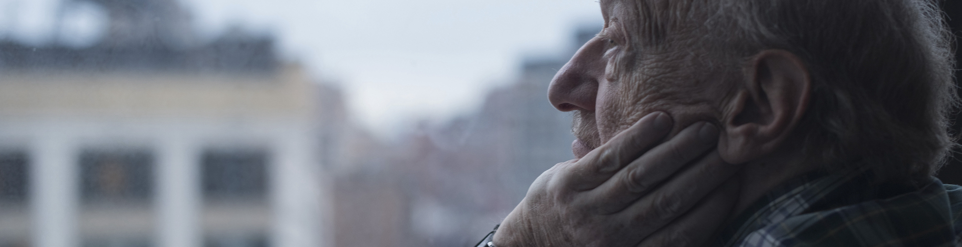 Man looking out of window, Manhattan, New York, USA