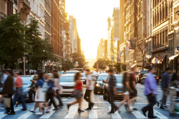 Crowds of people walking across a busy crosswalk at the intersection of 23rd Street and 5th Avenue in Manhattan New York City