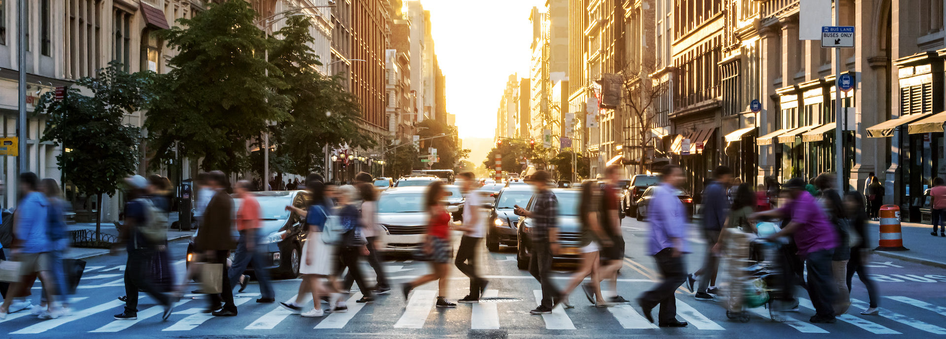 Crowds of people walking across a busy crosswalk at the intersection of 23rd Street and 5th Avenue in Manhattan New York City