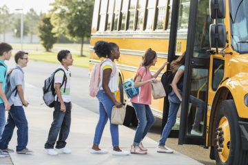 Middle school students boarding a bus