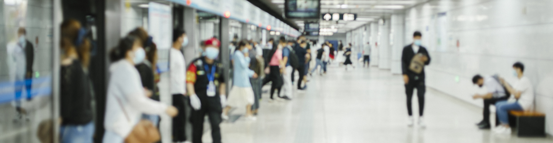 Crowd of busy commuters with protective face mask walking in beijing subway