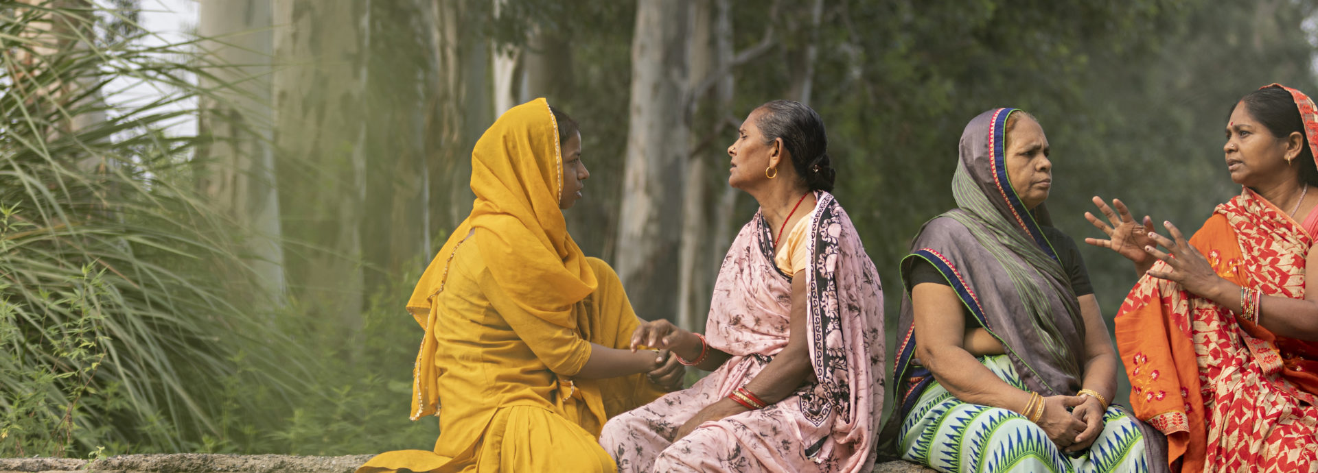 Four women sitting and talking