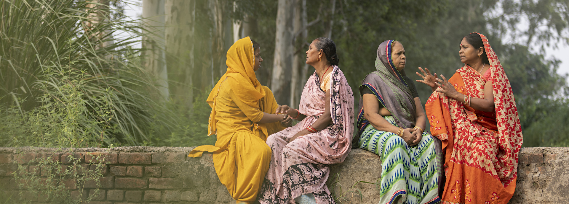 Four women sitting and talking