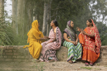 Four women sitting and talking