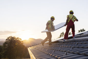 Installation of solar panels on a roof.