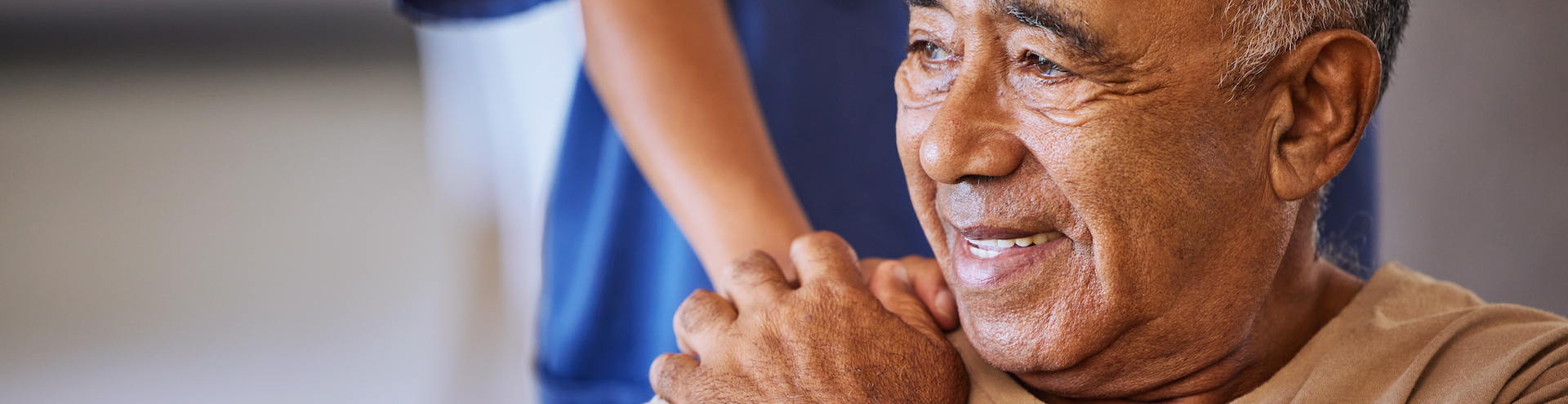 Nurse or doctor give man support during recovery or loss. Caregiver holding hand of her sad senior patient and showing kindness while doing a checkup at a retirement, old age home or hospital