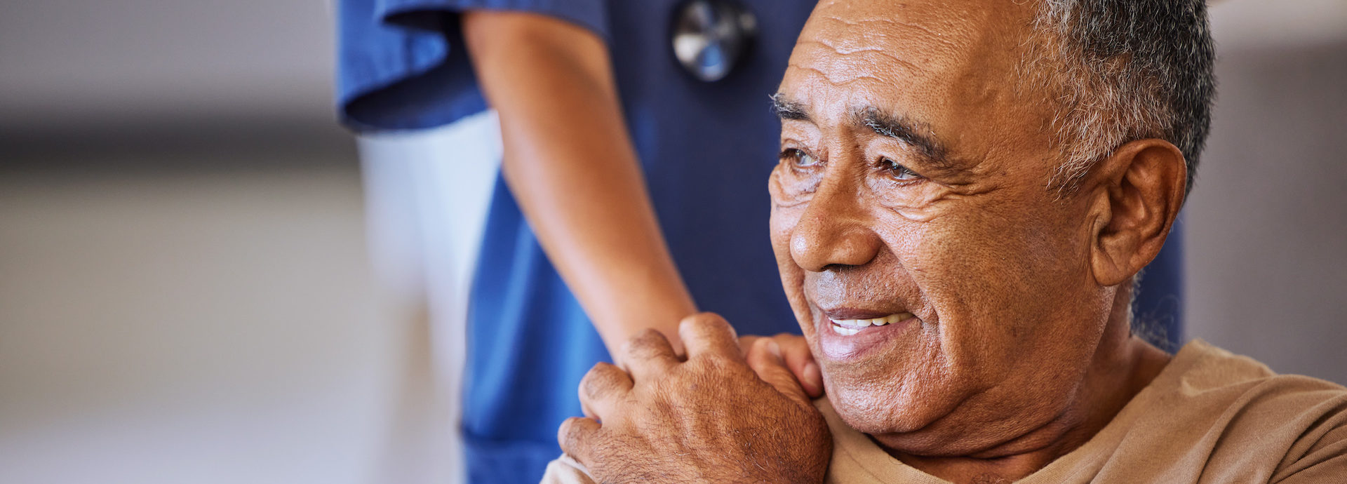Nurse or doctor give man support during recovery or loss. Caregiver holding hand of her sad senior patient and showing kindness while doing a checkup at a retirement, old age home or hospital