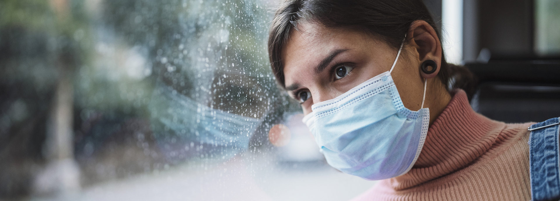 Woman Travelling In Bus And Wearing A Face Mask