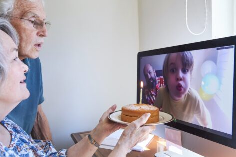 Family celebrating a birthday together via video call