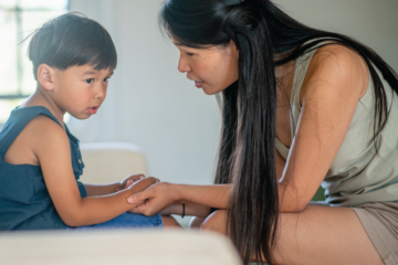 A mother talks to her young child.