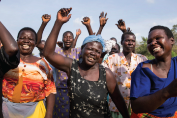 Ugandan women walking and cheering